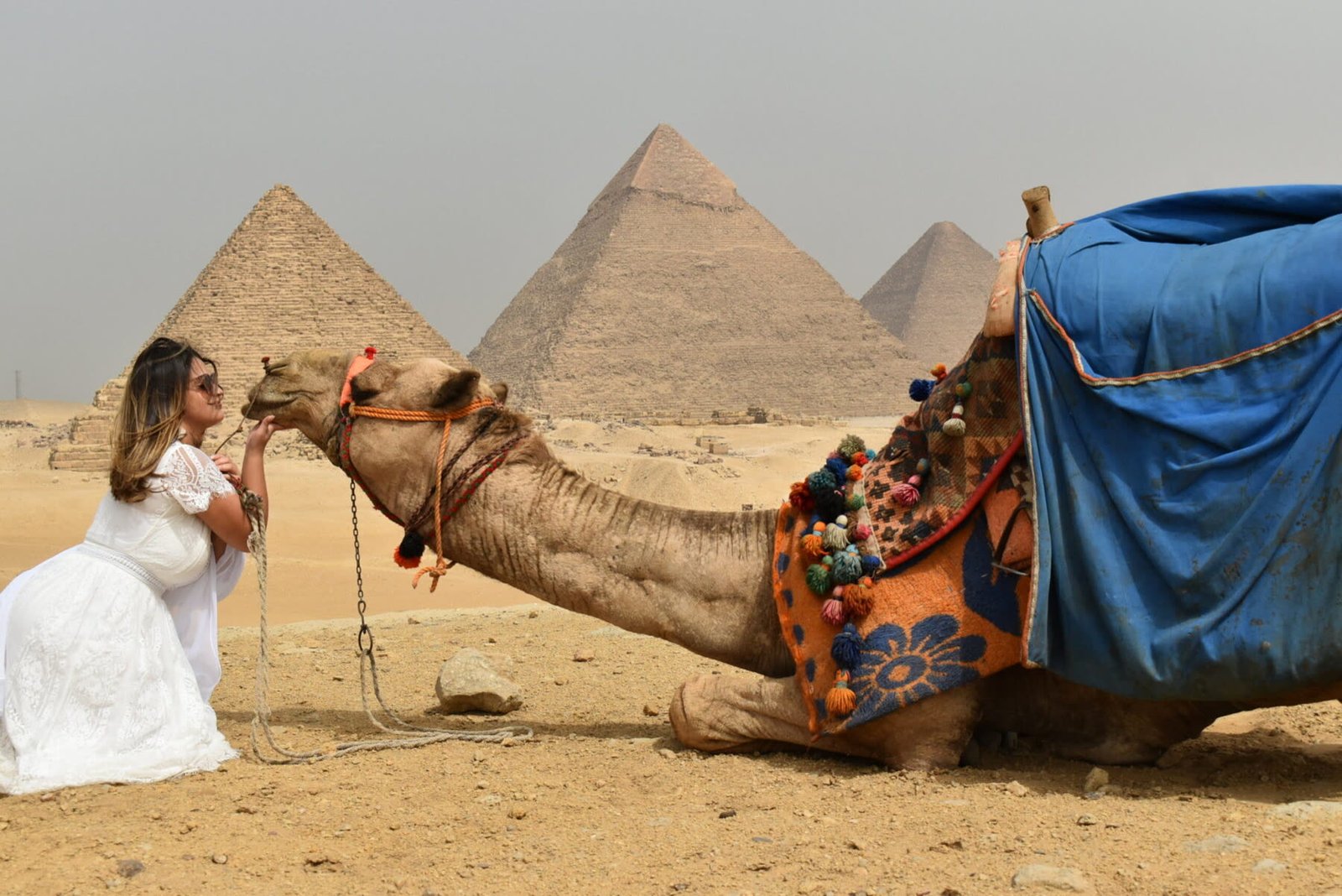 Traveler riding a camel beside the Pyramids of Giza on a Cairo and Nile cruise package